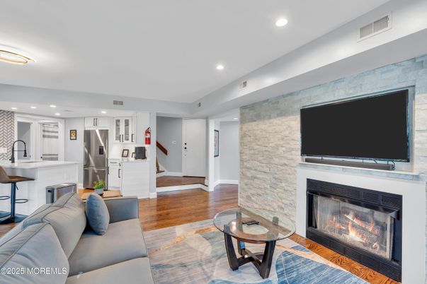 Fireplace, Interior, Kitchen, Living room, Recessed Lighting, Stainless Steel Appliances, Stone Walls, Wood Texture Flooring