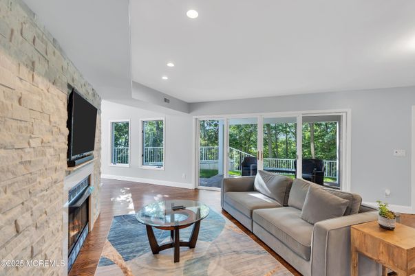 Fireplace, Interior, Living room, Recessed Lighting, Stone Walls, Wood Texture Flooring