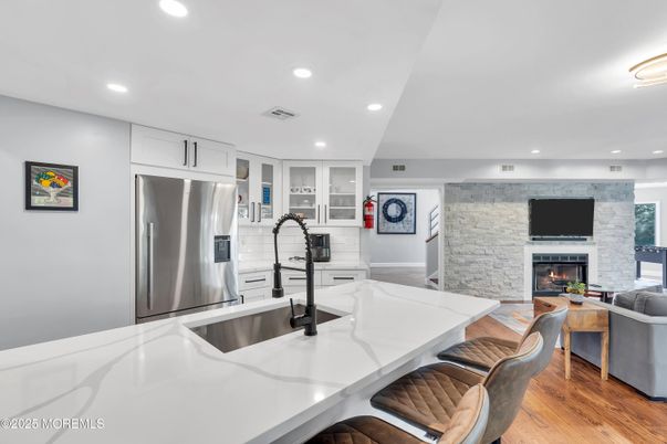 Fireplace, Interior, Kitchen, Recessed Lighting, Stainless Steel Appliances, Stone Walls, Wood Texture Flooring