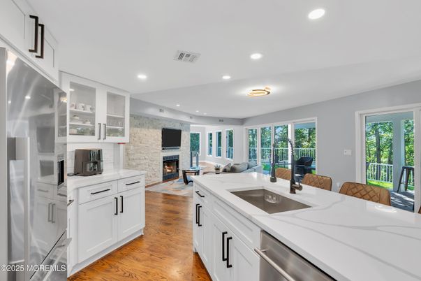 Fireplace, Interior, Kitchen, Living room, Recessed Lighting, Stainless Steel Appliances, Stone Walls, Wood Texture Flooring