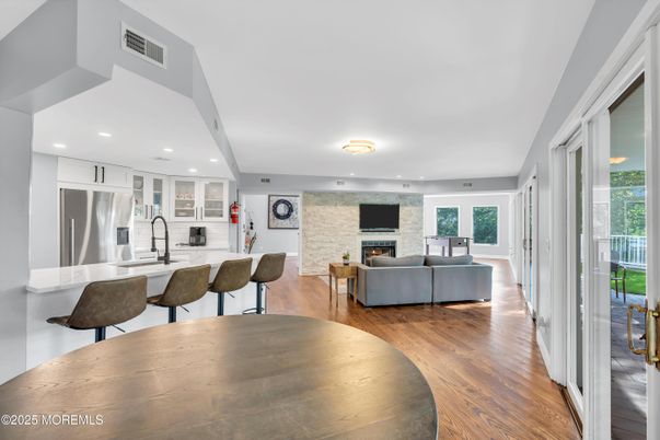Fireplace, Interior, Kitchen, Living room, Recessed Lighting, Stainless Steel Appliances, Stone Walls, Wood Texture Flooring