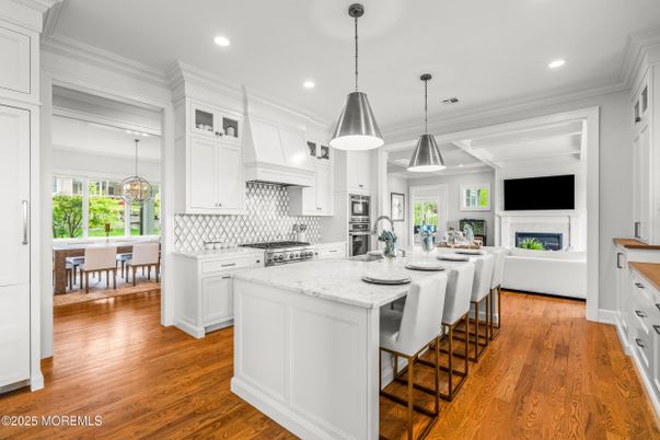 Dining room, Fireplace, Interior, Kitchen, Pendant Lights, Recessed Lighting, Stainless Steel Appliances, Wood Texture Flooring