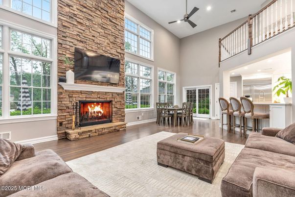 Dining room, Fireplace, Interior, Living room, Recessed Lighting, Stone Walls, Wood Texture Flooring