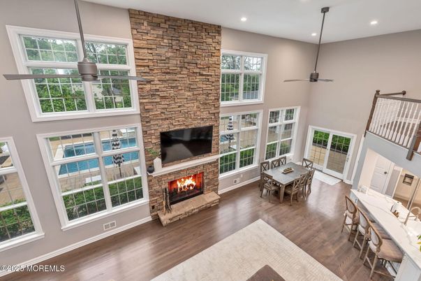 Dining room, Fireplace, Interior, Recessed Lighting, Stone Walls, Wood Texture Flooring