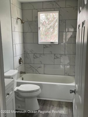 Bathroom, Glass Shower, Interior, Marble Walls, Wood Texture Flooring