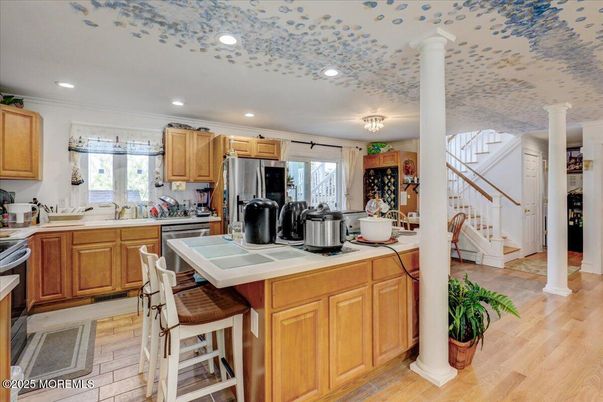 Interior, Kitchen, Recessed Lighting, Tile Countertops, Wood Texture Flooring