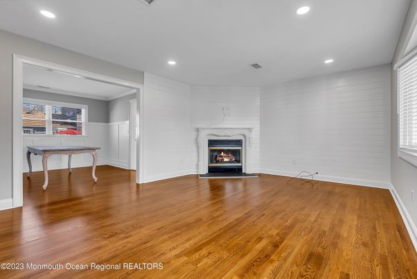 Empty room, Fireplace, Game Room, Interior, Recessed Lighting, Wood Texture Flooring