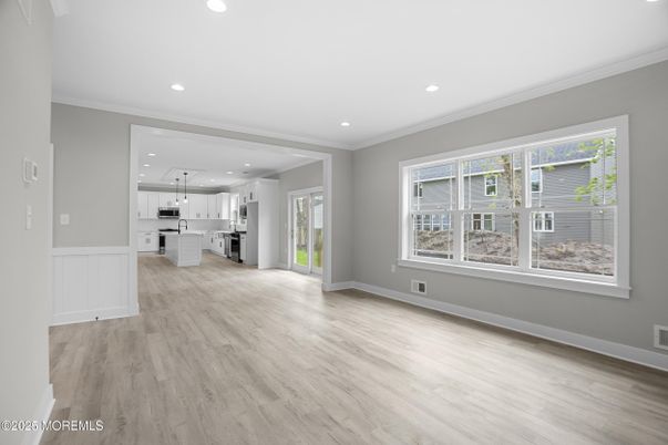 Empty room, Interior, Kitchen, Recessed Lighting, Stainless Steel Appliances, Wood Texture Flooring