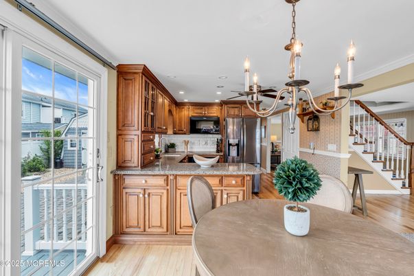 Chandelier, Dining room, Interior, Kitchen, Pendant Lights, Recessed Lighting, Stainless Steel Appliances, Wood Texture Flooring