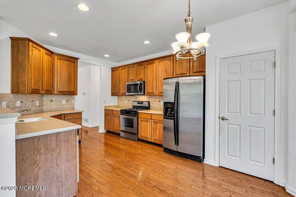 Chandelier, Interior, Kitchen, Recessed Lighting, Stainless Steel Appliances, Wood Texture Flooring