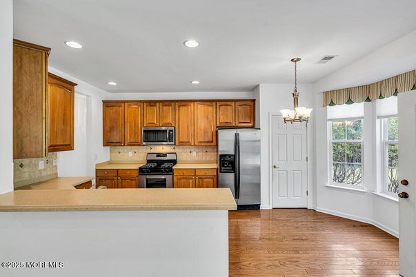 Chandelier, Interior, Kitchen, Pendant Lights, Recessed Lighting, Stainless Steel Appliances, Wood Texture Flooring