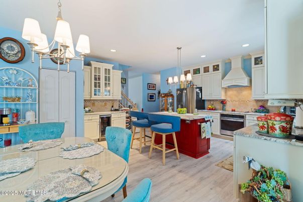 Chandelier, Dining room, Interior, Kitchen, Pendant Lights, Recessed Lighting, Stainless Steel Appliances, Wood Texture Flooring