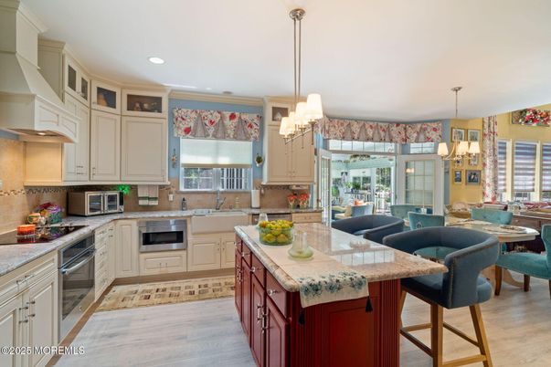 Chandelier, Dining room, Interior, Kitchen, Living room, Pendant Lights, Recessed Lighting, Stainless Steel Appliances, Wood Texture Flooring