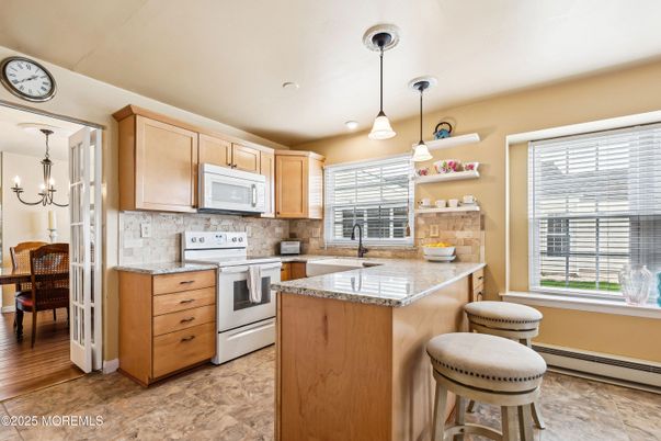 Chandelier, Dining room, Interior, Kitchen, Pendant Lights, Recessed Lighting, Stainless Steel Appliances, Wood Texture Flooring
