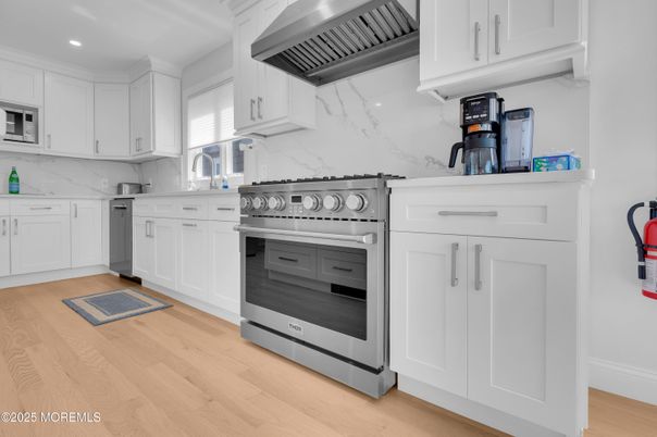 Interior, Kitchen, Marble Walls, Recessed Lighting, Stainless Steel Appliances, Wood Texture Flooring