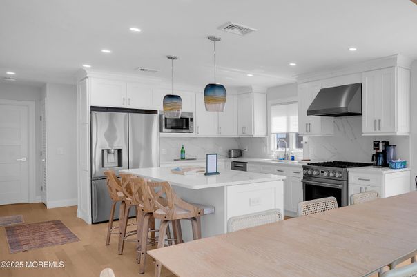 Interior, Kitchen, Marble Walls, Pendant Lights, Recessed Lighting, Stainless Steel Appliances, Wood Texture Flooring