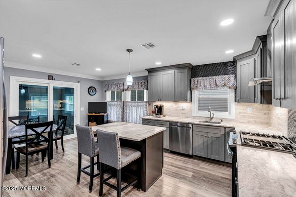 Dining room, Interior, Kitchen, Pendant Lights, Recessed Lighting, Stainless Steel Appliances, Wood Texture Flooring