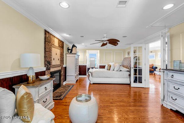 Bedroom, Fireplace, Interior, Living room, Recessed Lighting, Stone Walls, Wood Texture Flooring