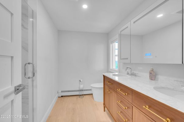Bathroom, Dual Sink Vanities, Glass Shower, Interior, Recessed Lighting, Wood Texture Flooring