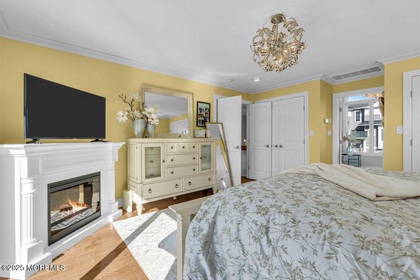Bedroom, Chandelier, Fireplace, Interior, Recessed Lighting, Wood Texture Flooring