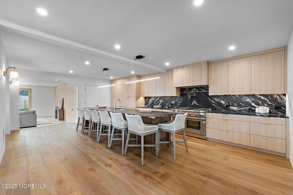 Interior, Kitchen, Marble Walls, Recessed Lighting, Stainless Steel Appliances, Wood Texture Flooring