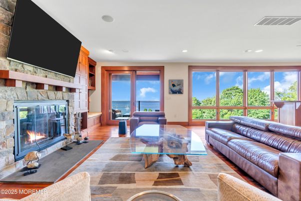 Fireplace, Interior, Living room, Recessed Lighting, Stone Walls, Water, Wood Texture Flooring