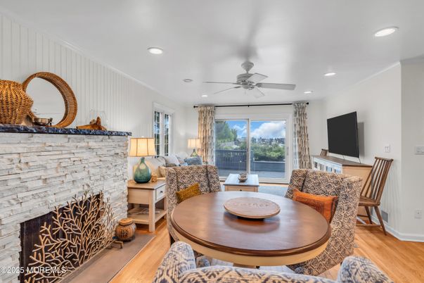 Dining room, Fireplace, Interior, Living room, Recessed Lighting, Stone Walls, Wood Texture Flooring