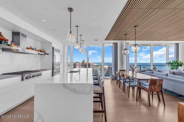 Dining room, Interior, Kitchen, Marble Walls, Pendant Lights, Recessed Lighting, Stainless Steel Appliances, Water, Wood Texture Flooring