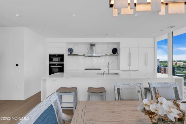 Interior, Kitchen, Marble Walls, Recessed Lighting, Stainless Steel Appliances, Wood Texture Flooring
