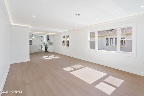 Empty room, Interior, Kitchen, Recessed Lighting, Stainless Steel Appliances, Wood Texture Flooring