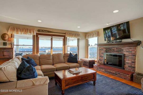 Fireplace, Interior, Living room, Recessed Lighting, Water, Wood Texture Flooring