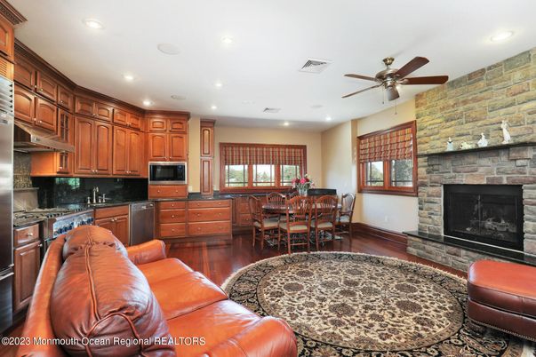 Dining room, Fireplace, Interior, Kitchen, Living room, Recessed Lighting, Stone Walls, Wood Texture Flooring