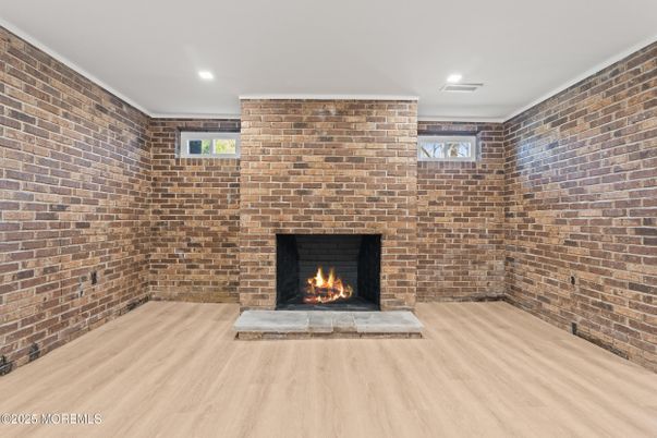 Empty room, Fireplace, Interior, Recessed Lighting, Stone Walls, Wood Texture Flooring