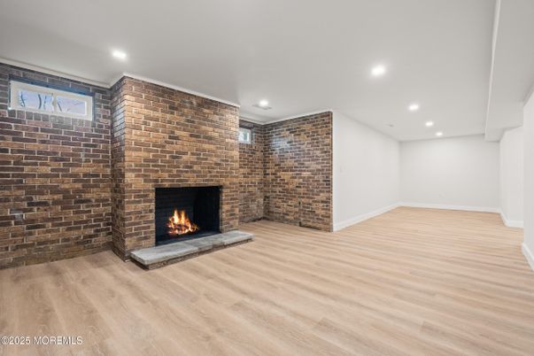 Empty room, Fireplace, Interior, Recessed Lighting, Stone Walls, Wood Texture Flooring