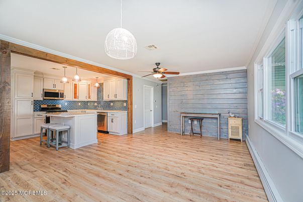 Empty room, Interior, Kitchen, Pendant Lights, Stainless Steel Appliances, Stone Walls, Wood Texture Flooring