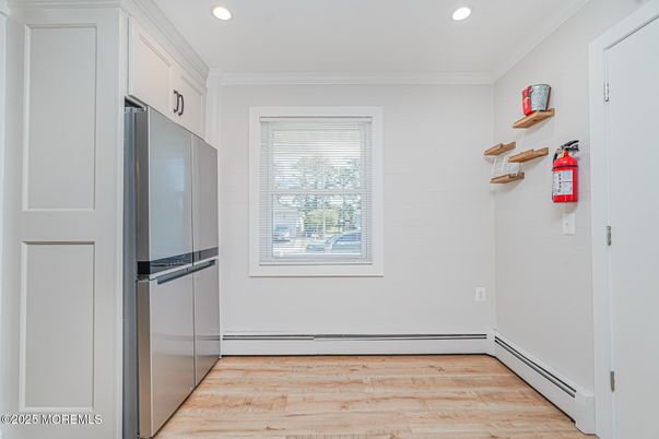 Empty room, Interior, Kitchen, Recessed Lighting, Stainless Steel Appliances, Wood Texture Flooring