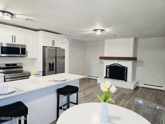 Fireplace, Interior, Kitchen, Stainless Steel Appliances, Wood Texture Flooring