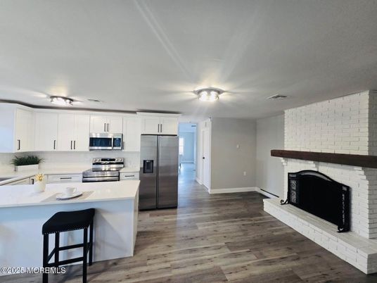 Fireplace, Interior, Kitchen, Stainless Steel Appliances, Wood Texture Flooring