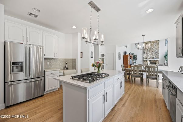 Chandelier, Dining room, Interior, Kitchen, Pendant Lights, Recessed Lighting, Stainless Steel Appliances, Wood Texture Flooring