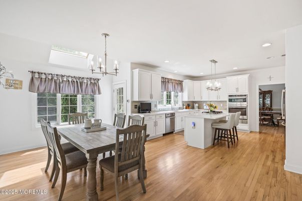 Chandelier, Dining room, Interior, Kitchen, Pendant Lights, Recessed Lighting, Stainless Steel Appliances, Wood Texture Flooring