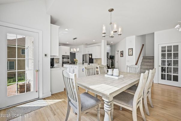 Chandelier, Dining room, Interior, Kitchen, Pendant Lights, Recessed Lighting, Stainless Steel Appliances, Wood Texture Flooring