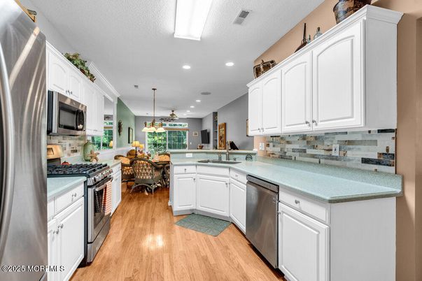 Dining room, Interior, Kitchen, Pendant Lights, Recessed Lighting, Stainless Steel Appliances, Wood Texture Flooring