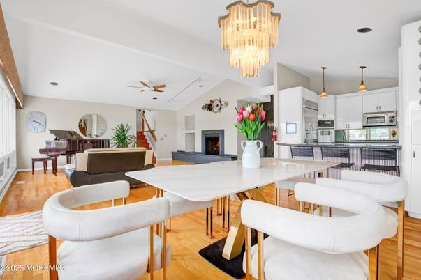 Chandelier, Fireplace, Interior, Kitchen, Living room, Pendant Lights, Piano, Stainless Steel Appliances, Wood Texture Flooring