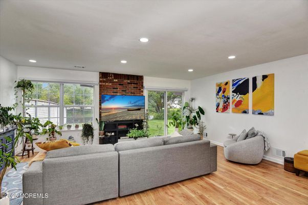 Fireplace, Interior, Living room, Recessed Lighting, Stone Walls, Wood Texture Flooring