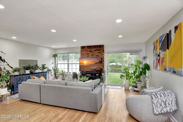 Fireplace, Interior, Living room, Recessed Lighting, Stone Walls, Wood Texture Flooring