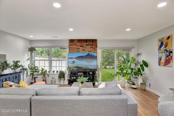 Fireplace, Interior, Living room, Recessed Lighting, Stone Walls, Wood Texture Flooring