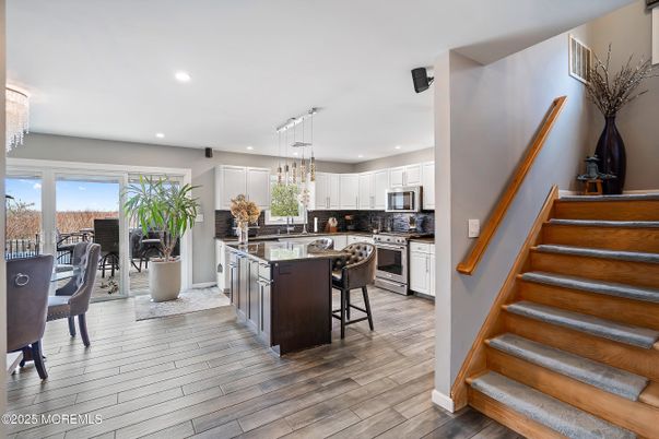Chandelier, Dining room, Interior, Kitchen, Pendant Lights, Recessed Lighting, Stainless Steel Appliances, Wood Texture Flooring