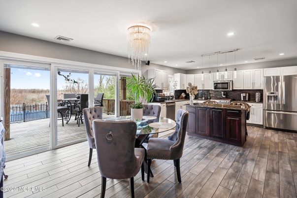Chandelier, Dining room, Interior, Kitchen, Pendant Lights, Recessed Lighting, Stainless Steel Appliances, Wood Texture Flooring