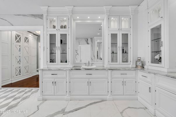 Bathroom, Dual Sink Vanities, Interior, Marble, Marble Walls, Recessed Lighting, Wood Texture Flooring
