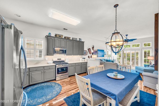 Chandelier, Dining room, Interior, Kitchen, Living room, Pendant Lights, Stainless Steel Appliances, Wood Texture Flooring